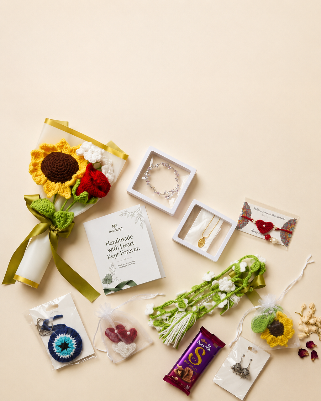 Everything inside the Rakhi hamper laid out: crochet sunflower and rose bouquet, keepsake card, bracelet, necklace, rakhi, paranda, evil eye and sunflower keychains, crochet hearts, jhumka earrings and chocolate