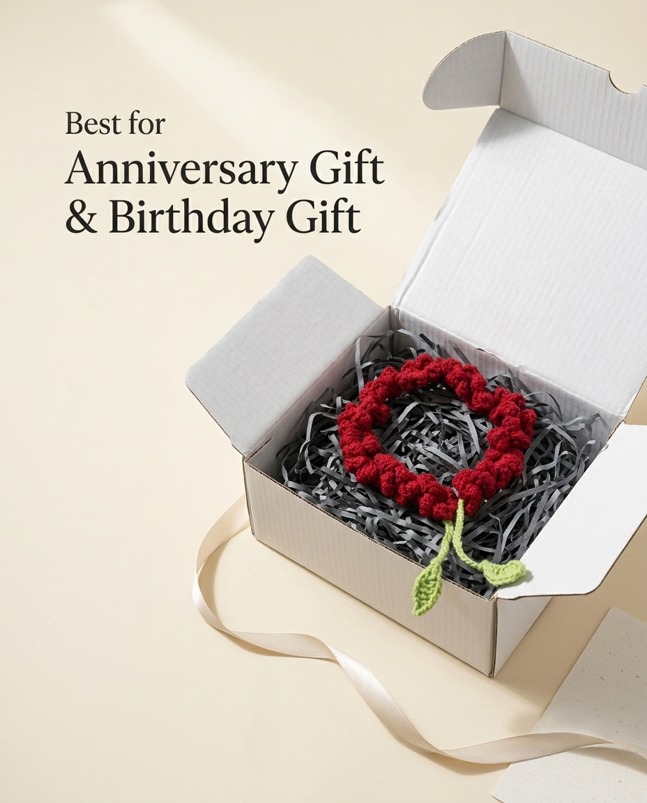 The red bun gajra packed in an open white gift box on grey shredded filler