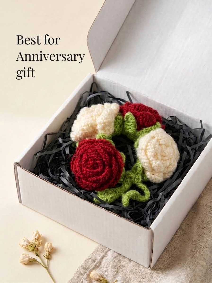 The rose gajra packed in an open white gift box on black shredded filler