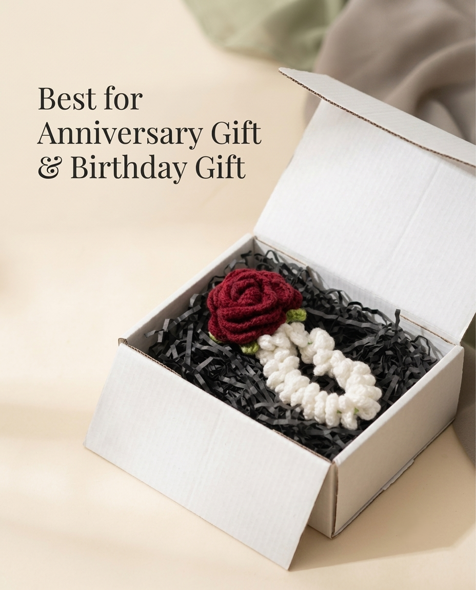 The gajra packed in an open white gift box on black shredded filler