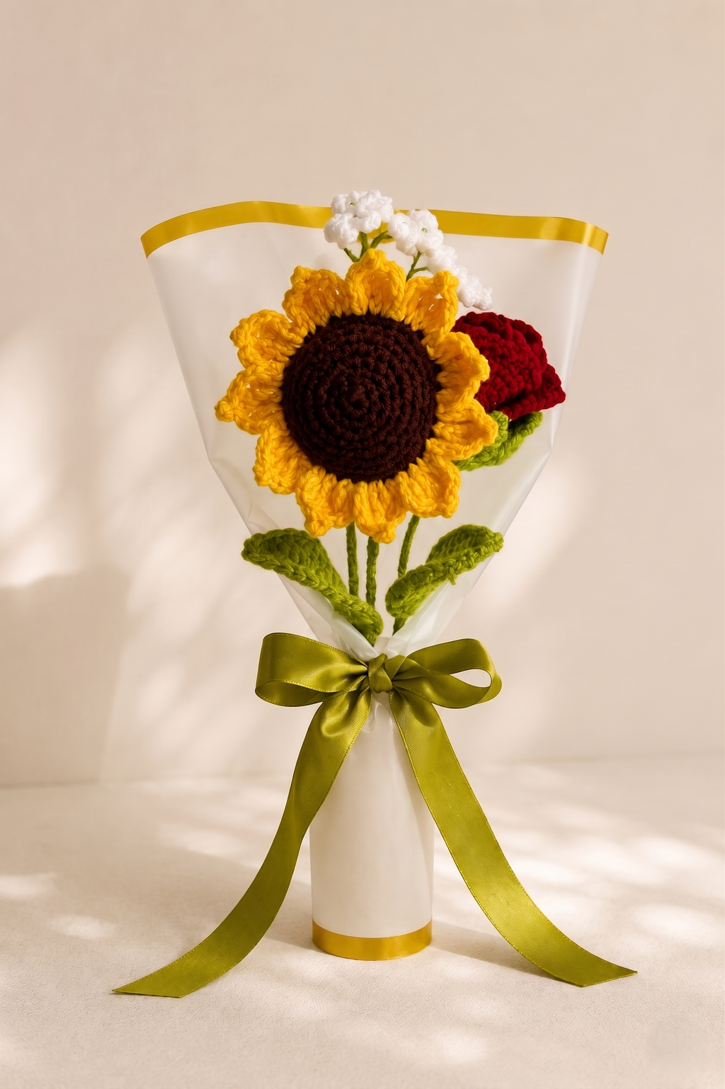 Crochet sunflower and rose bouquet wrapped in cream paper with an olive ribbon