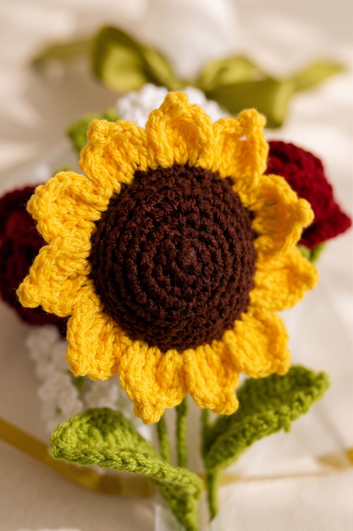 The bouquet from a second angle, showing the crochet sunflower and rose heads